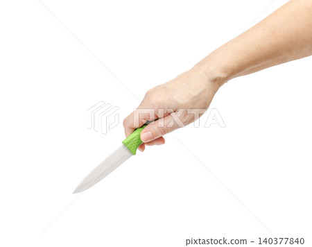 Woman's hand holding a kitchen knife on the white background. Woman's hand holding a kitchen knife on the white background. 140377840