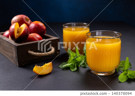 Refreshing nectarine juice in glasses with fresh fruit Refreshing nectarine juice in glasses with fresh fruit 140378094