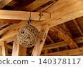 A traditional wooden building in Kaneyama Town, Yamagata Prefecture, with beams and a round hemp rope lamp hanging from them. 140378117