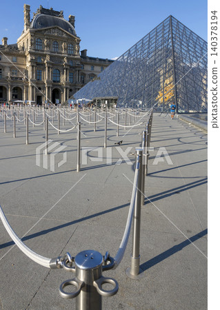 Paris, France - July 04, 2018: Pyramid of the Louvre and a fragment of the fountain 140378194