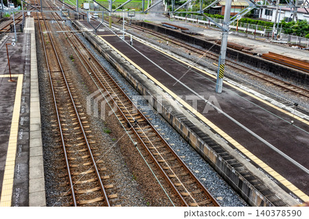 A view of the train station platform and the straight railway tracks (aerial view). A view of the train station platform and the straight railway tracks (aerial view). 140378590
