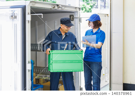 Senior workers and female drivers loading trucks 140378961