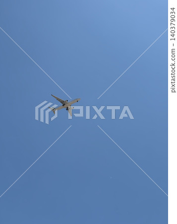 Commercial Twin Engine Jet Plane Overhead in Cloudless Blue Sky Upward View Commercial Twin Engine Jet Plane Overhead in Cloudless Blue Sky Upward View 140379034