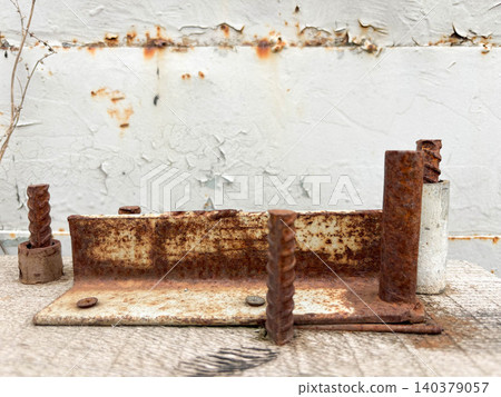 industrial decay and weathering. a heavily corroded metal bracket rests surface. Vertical image industrial decay and weathering. a heavily corroded metal bracket rests surface. Vertical image 140379057