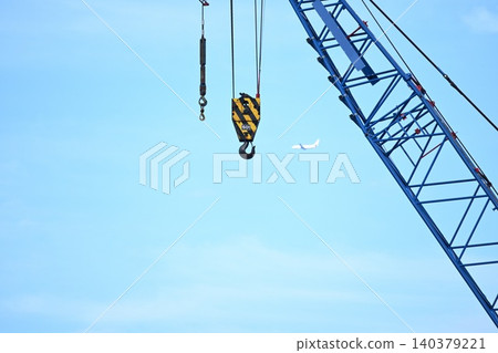 A crane extending into the blue sky A crane extending into the blue sky 140379221
