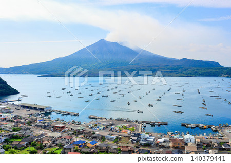 The townscape of Kaigata Fishing Port and the majestic Sakurajima as seen from Niko Observatory. The townscape of Kaigata Fishing Port and the majestic Sakurajima as seen from Niko Observatory. 140379441