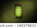 Mobile phone with soccer field screen on green grass lawn texture	 140379633