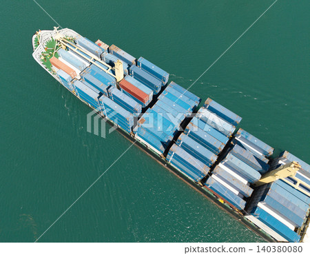 Container ship. Export and import. Cargo business. Shipping logistics. Cargo ship with container, aerial top view. Freight container on cargo vessel. Cargo ship vessel leaving port. Commercial vessel Container ship. Export and import. Cargo business. Shipping logistics. Cargo ship with container, aerial top view. Freight container on cargo vessel. Cargo ship vessel leaving port. Commercial vessel 140380080