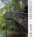 Modern steel walkway in lush green forest park 140380215