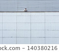 Gray Industrial Warehouse Wall Metal Panel Grid Texture with Security Camera 140380216