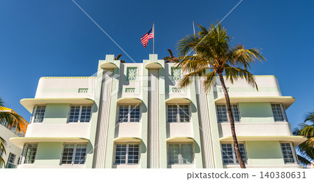 Miami Beach in Ocean Drive Florida. Art Deco building architecture. Architectural building. Art deco. Architectural district Art Deco. Modern building of Miami beach with American flag. Ocean drive Miami Beach in Ocean Drive Florida. Art Deco building architecture. Architectural building. Art deco. Architectural district Art Deco. Modern building of Miami beach with American flag. Ocean drive 140380631