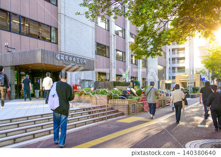 Fukuoka City, Fukuoka Prefecture, Chuo Ward Office entrance, bustling streetscape, evening. Fukuoka City, Fukuoka Prefecture, Chuo Ward Office entrance, bustling streetscape, evening. 140380640