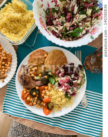 A filling, balanced breakfast with lentil and zucchini pancakes, millet, baked chicken neck, roasted sweet potatoes, broccoli, carrots, chickpeas, and a fresh salad with radish, sprouts, and nuts A filling, balanced breakfast with lentil and zucchini pancakes, millet, baked chicken neck, roasted sweet potatoes, broccoli, carrots, chickpeas, and a fresh salad with radish, sprouts, and nuts 140380836
