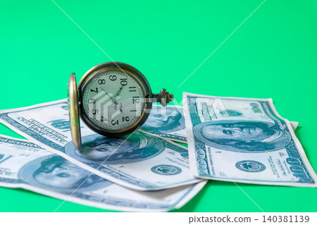 Vintage pocket o'clock over a bank note. Vintage pocket o'clock over a bank note. 140381139