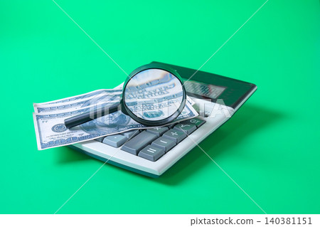 Bank note on calculator with magnifying glass,Business concept. Bank note on calculator with magnifying glass,Business concept. 140381151