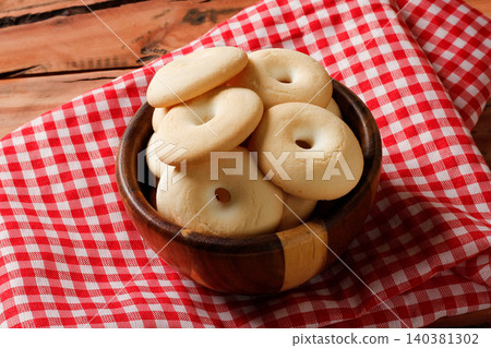 Crunchy Brazilian Cassava Starch Cookies on Rustic Wooden Table with Red Checkered Cloth Crunchy Brazilian Cassava Starch Cookies on Rustic Wooden Table with Red Checkered Cloth 140381302