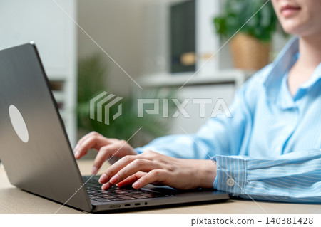 Close up hands of woman type on keyboard of laptop during work in the office and she look expert to typing. Close up hands of woman type on keyboard of laptop during work in the office and she look expert to typing. 140381428