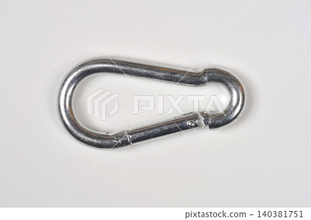 Metallic spring snap hook carabiner on white background Metallic spring snap hook carabiner on white background 140381751