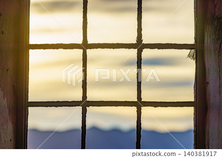 Old building with iron barred window and mountains nature seen through cell bars. Old building with iron barred window and mountains nature seen through cell bars. 140381917