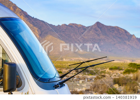 Black windshield wipers raised on camper vehicle hood Black windshield wipers raised on camper vehicle hood 140381919
