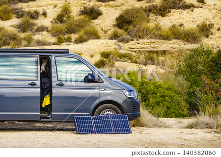 Portable solar photovoltaic panel, charging battery at camper van vehicle. Portable solar photovoltaic panel, charging battery at camper van vehicle. 140382060