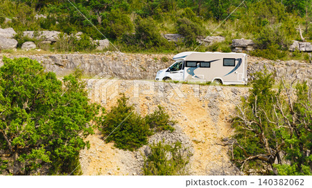 RV travels along a rocky road in a green landscape. Verdon Gorge in France RV travels along a rocky road in a green landscape. Verdon Gorge in France 140382062