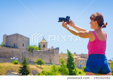 Tourist take picture from Aurel village, Vaucluse department in Provence-Alpes-Cote d'Azur, France. Tourist take picture from Aurel village, Vaucluse department in Provence-Alpes-Cote d'Azur, France. 140382092
