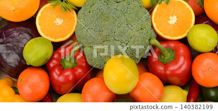 Abundance of fresh organic vegetables and citrus fruits including broccoli, bell peppers, oranges, and lemons 140382199