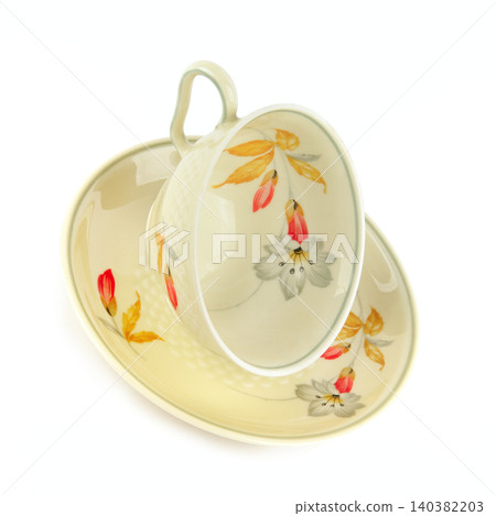 Elegant vintage porcelain teacup and saucer with floral pattern isolated on white background Elegant vintage porcelain teacup and saucer with floral pattern isolated on white background 140382203