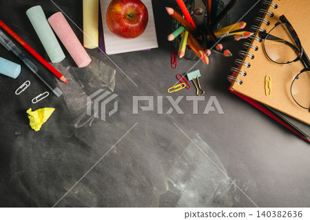 Blackboard workspace with school supplies and alarm clock, education background Blackboard workspace with school supplies and alarm clock, education background 140382636