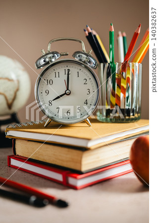 Academic planning with alarm clock on textbooks, study schedule concept Academic planning with alarm clock on textbooks, study schedule concept 140382637