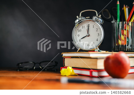 Back to School Supplies on Wooden Desk with Alarm Clock, Apple and Colored Pencils Back to School Supplies on Wooden Desk with Alarm Clock, Apple and Colored Pencils 140382668