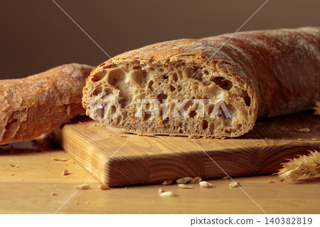 Fresh backed ciabatta bread on a wooden cutting board. Fresh backed ciabatta bread on a wooden cutting board. 140382819