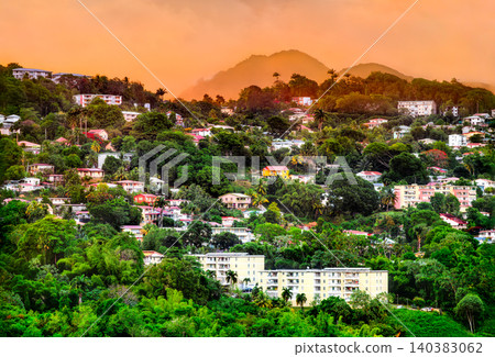 Scenic view of colorful houses and apartment buildings nestled on a lush green tropical hillside during sunset in Fort de France - Martinique, Caribbean France Scenic view of colorful houses and apartment buildings nestled on a lush green tropical hillside during sunset in Fort de France - Martinique, Caribbean France 140383062