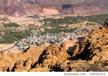 A high angle perspective of the Al Ula oasis and surrounding mountains from the Harrat Viewpoint in Saudi Arabia. A high angle perspective of the Al Ula oasis and surrounding mountains from the Harrat Viewpoint in Saudi Arabia. 140383325