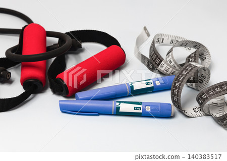 Ozempic weight loss concept with fitness equipment, measuring tape. Ozempic weight loss concept with fitness equipment, measuring tape. 140383517