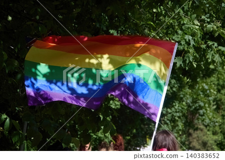 Pride flag weaving in sunlit green leaves Pride flag weaving in sunlit green leaves 140383652