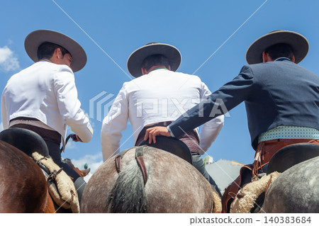 Three Horse Riders Wearing Traditional Andalusian Costume Seen from Behind 140383684