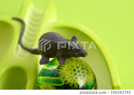 Mouse toy standing on abstract green orb Mouse toy standing on abstract green orb 140383745