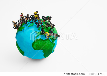 Cyclists racing global sustainability on miniature earth Cyclists racing global sustainability on miniature earth 140383749