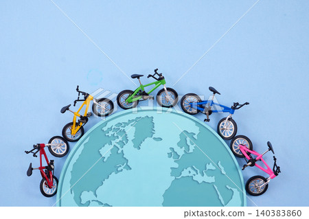 World bicycle day. Colorful bicycles riding on top of the world map World bicycle day. Colorful bicycles riding on top of the world map 140383860