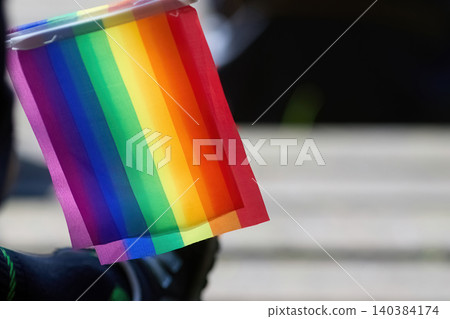 Holding rainbow flag representing lgbt pride and diversity Holding rainbow flag representing lgbt pride and diversity 140384174