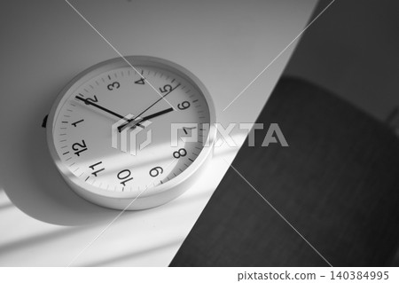 A mantel clock illuminated by oblique light. A mantel clock illuminated by oblique light. 140384995