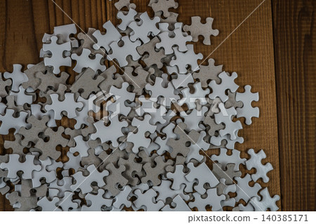 White jigsaw puzzle placed on the desk White jigsaw puzzle placed on the desk 140385171