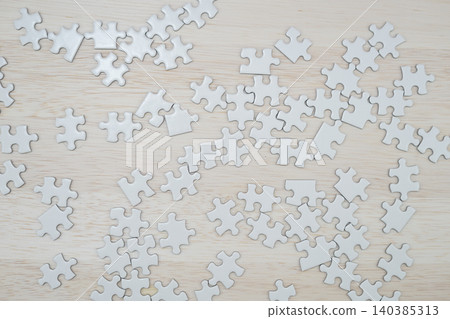 White jigsaw puzzle placed on the desk 140385313