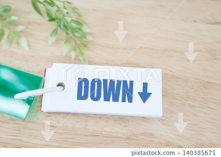 An image of decrease and decline. Blue text with the word "DOWN" and a downward arrow. Wooden background. An image of decrease and decline. Blue text with the word "DOWN" and a downward arrow. Wooden background. 140385671