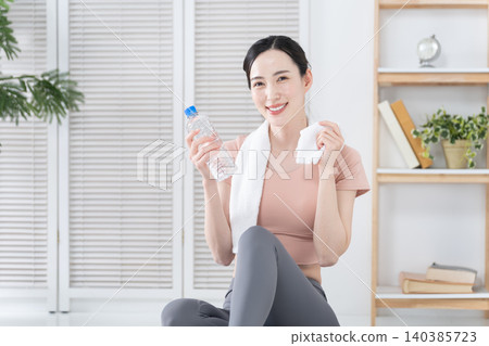 Women exercising and stretching at home Women exercising and stretching at home 140385723