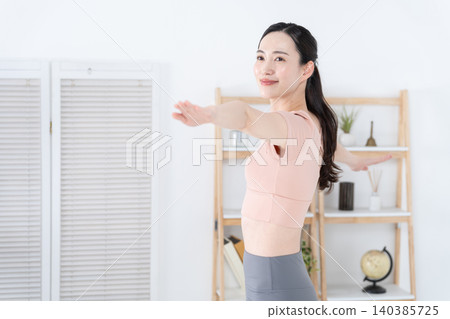 A woman doing yoga at home 140385725