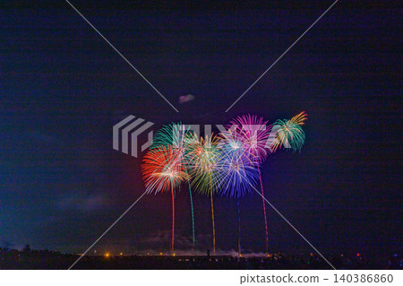 Colorful starbursts shining in the night sky Colorful starbursts shining in the night sky 140386860