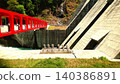 A scenic spot offering breathtaking views of a massive dam built in a mountainous region. 140386891